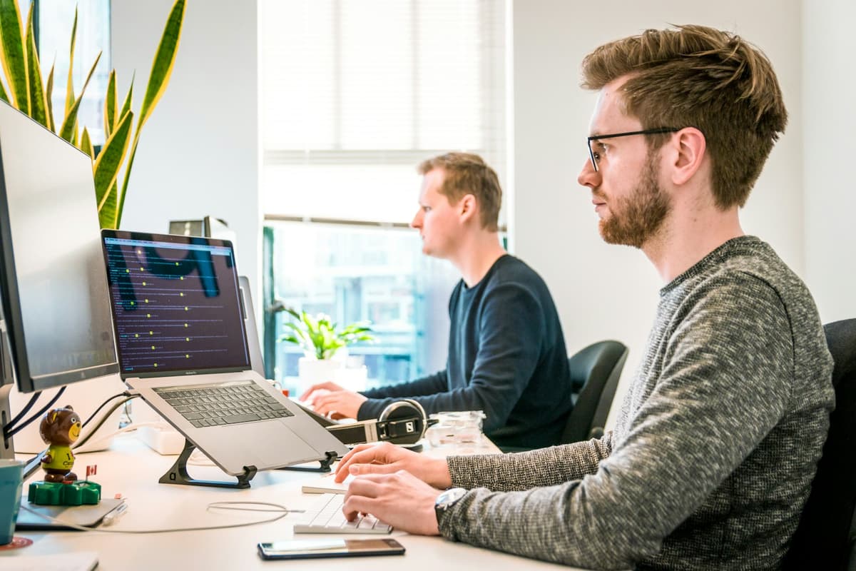 Professional working with spreadsheet data on a laptop